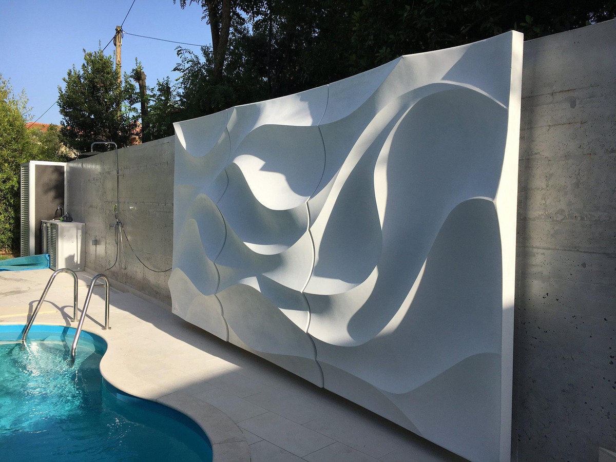 Installed sculptural wall illuminated by the sun