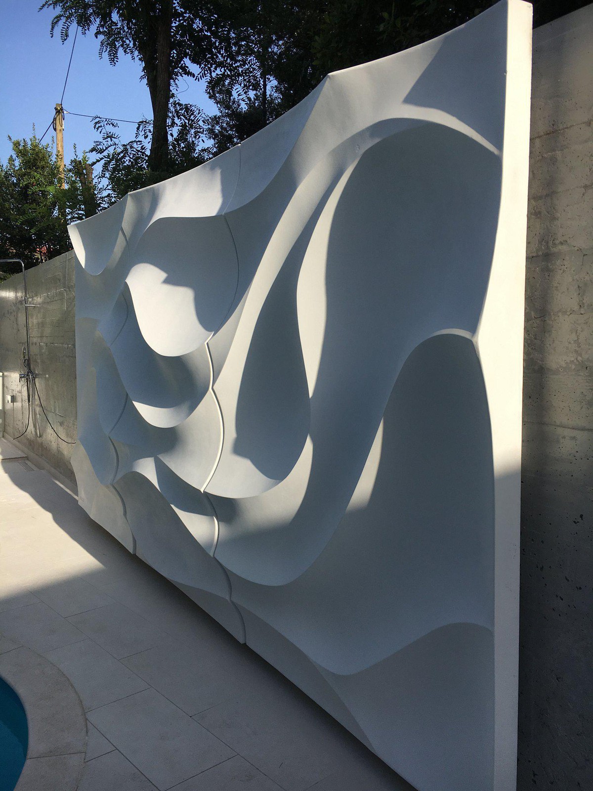 Installed sculptural wall illuminated by the sun